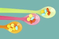 Three colorful spoons hold 5 or six pills each