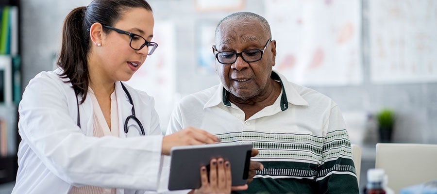 doctor showing a man a tablet