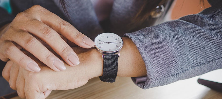 business woman checking wristwatch close up