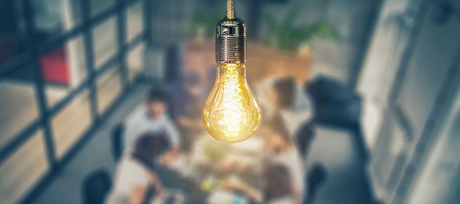 lightbulb above meeting table