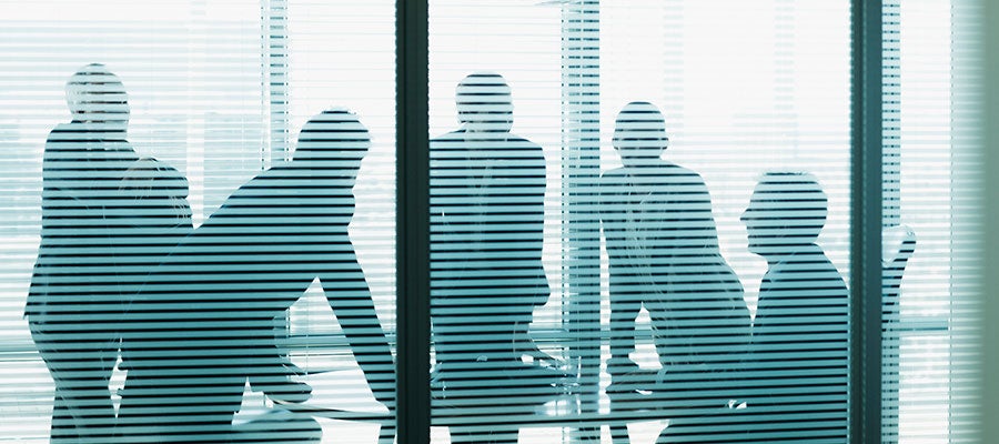 board meeting behind blind-covered windows