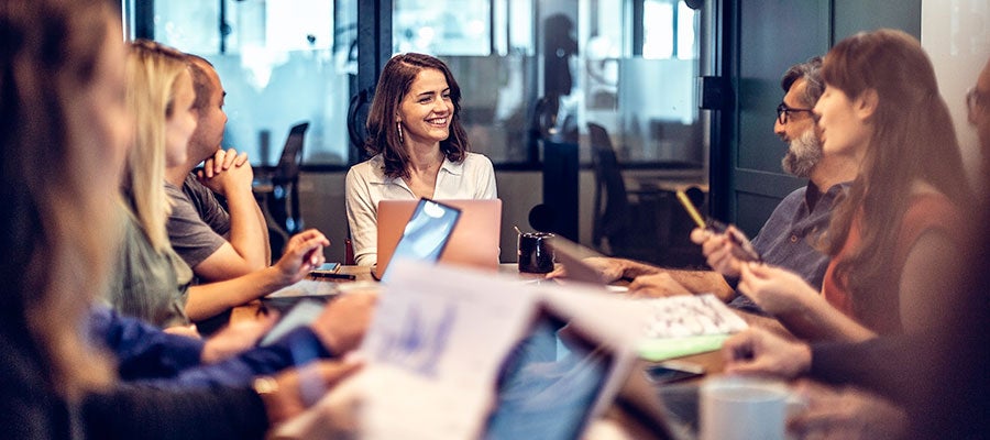 young woman at busy meeting