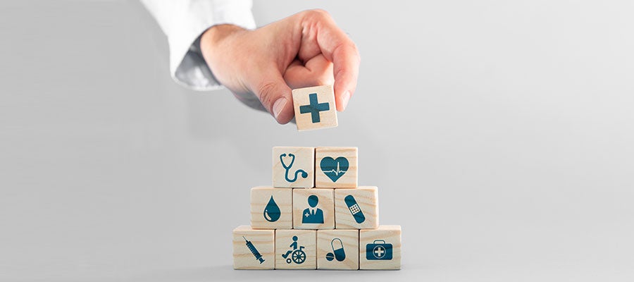 doctor hand stacking health icon blocks