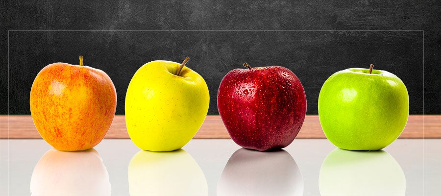 apple varieties in front of blackboard
