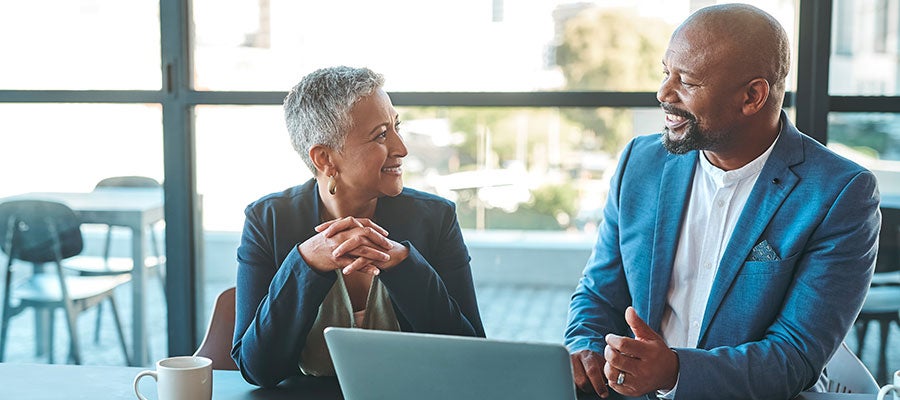 Man and woman consulting over computer