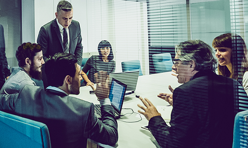 How the Board Influences a Culture of Safety. A board sitting around a conference table discuss a culture of safety.