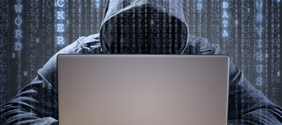 hooded figure over keyboard