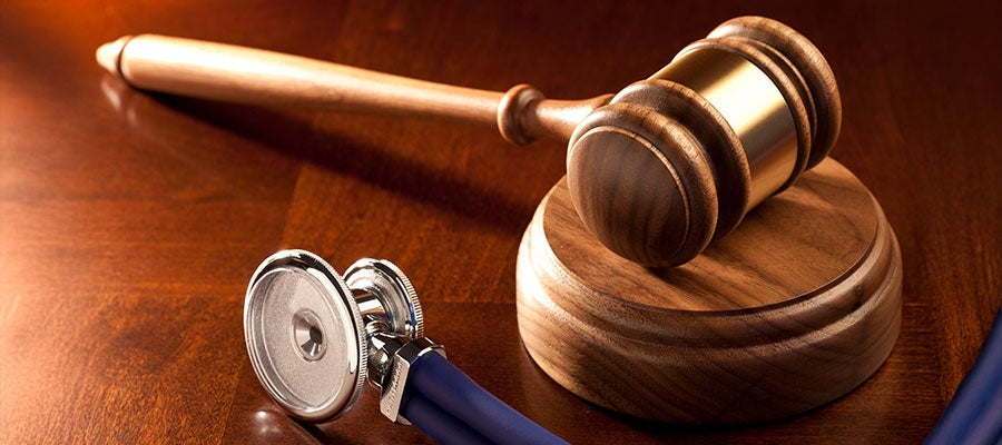 Medical compliance image of gavel and stethoscope