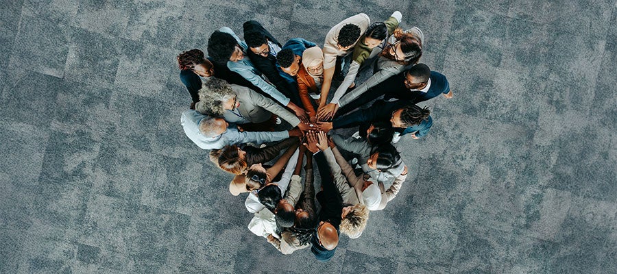 group of businesspeople hands in in shape of a heart
