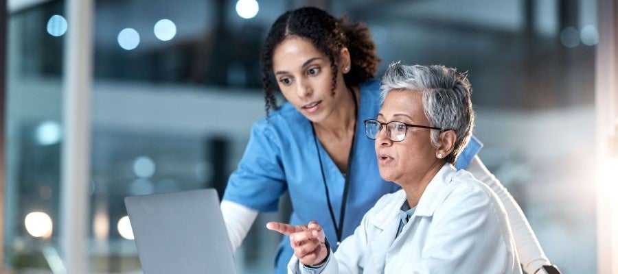 Two clinicians looking at a computer