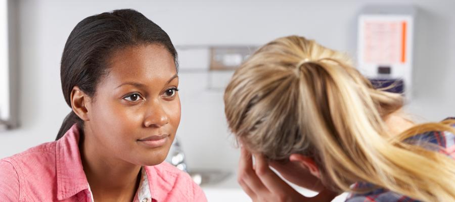 Black woman therapist talks to white patient